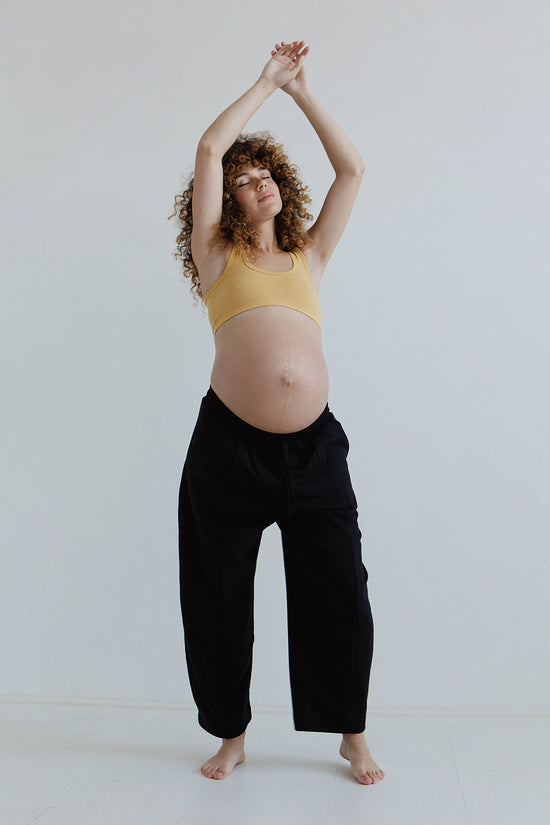 pregnant model wears black jersey jenny trousers