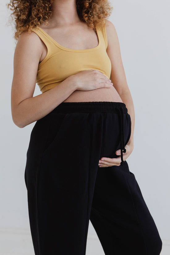 pregnant model wears black jersey jenny trousers