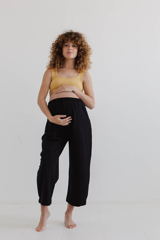 pregnant model wears black jersey jenny trousers