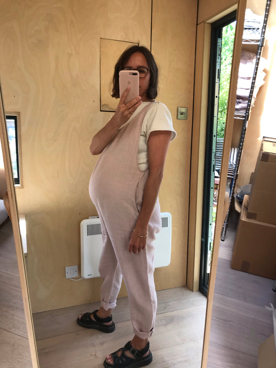 pregnant model wears linen rose laura jumpsuit