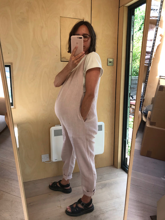 pregnant model wears linen rose laura jumpsuit